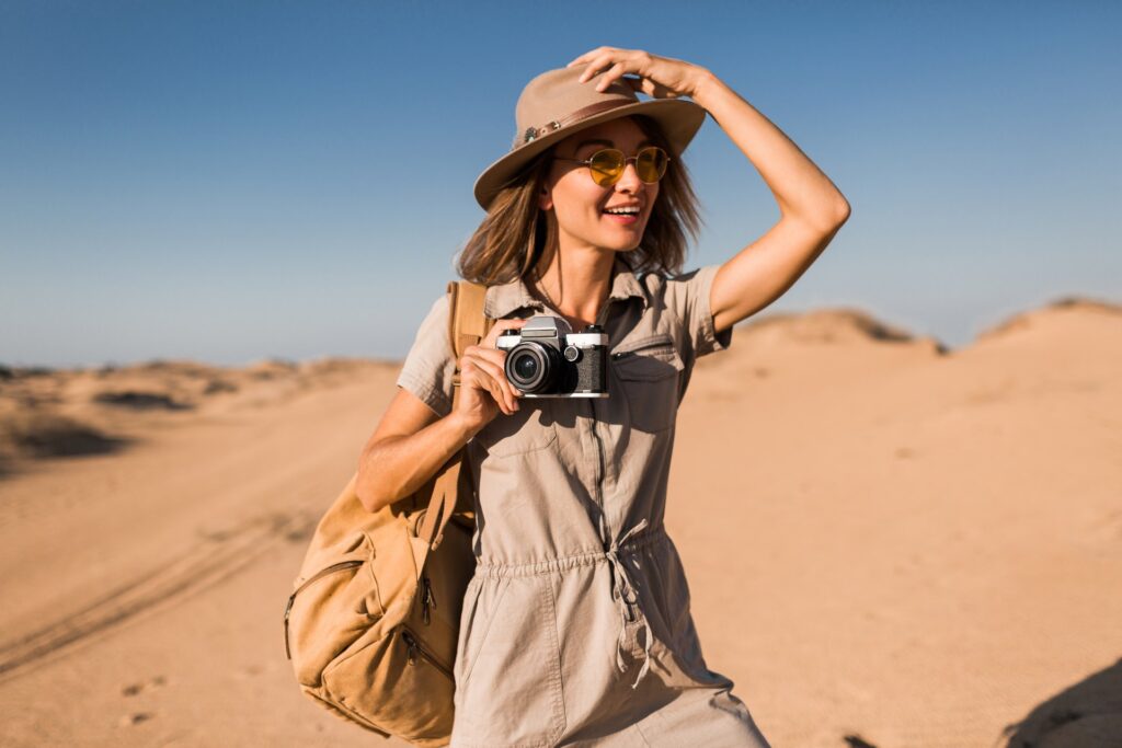 Woman on a desert safari in Egypt holding a camera